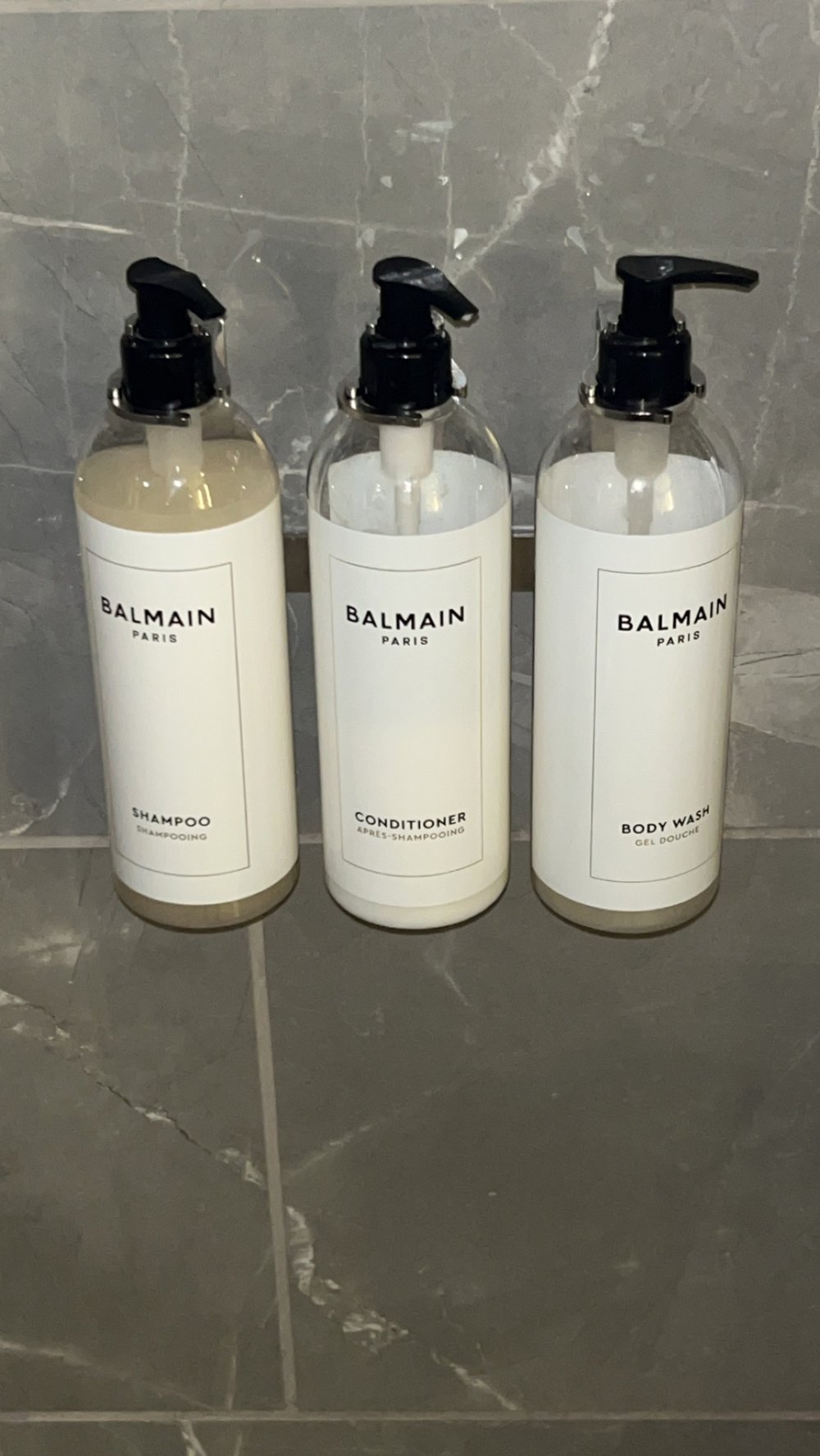 Balmain bath amenities lined up on the counter of the Grand Hyatt room