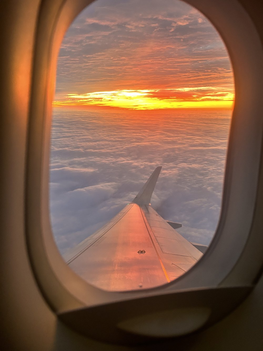 A sunset over the airplane wing, seen from the window seat on the way to Nashville
