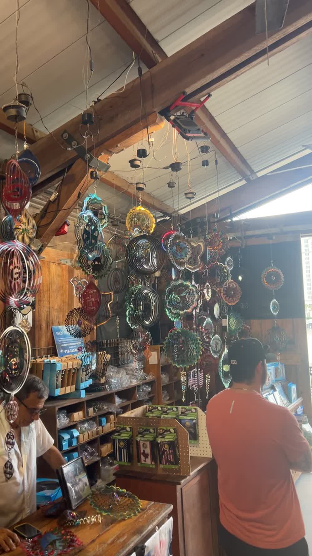Inside a riverfront shop in Savannah, hung with ornaments and local goods